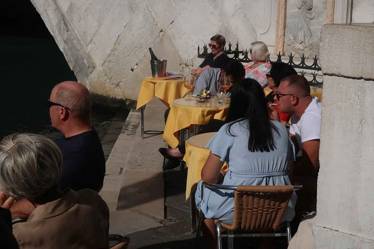 tourists enjoying venice sun