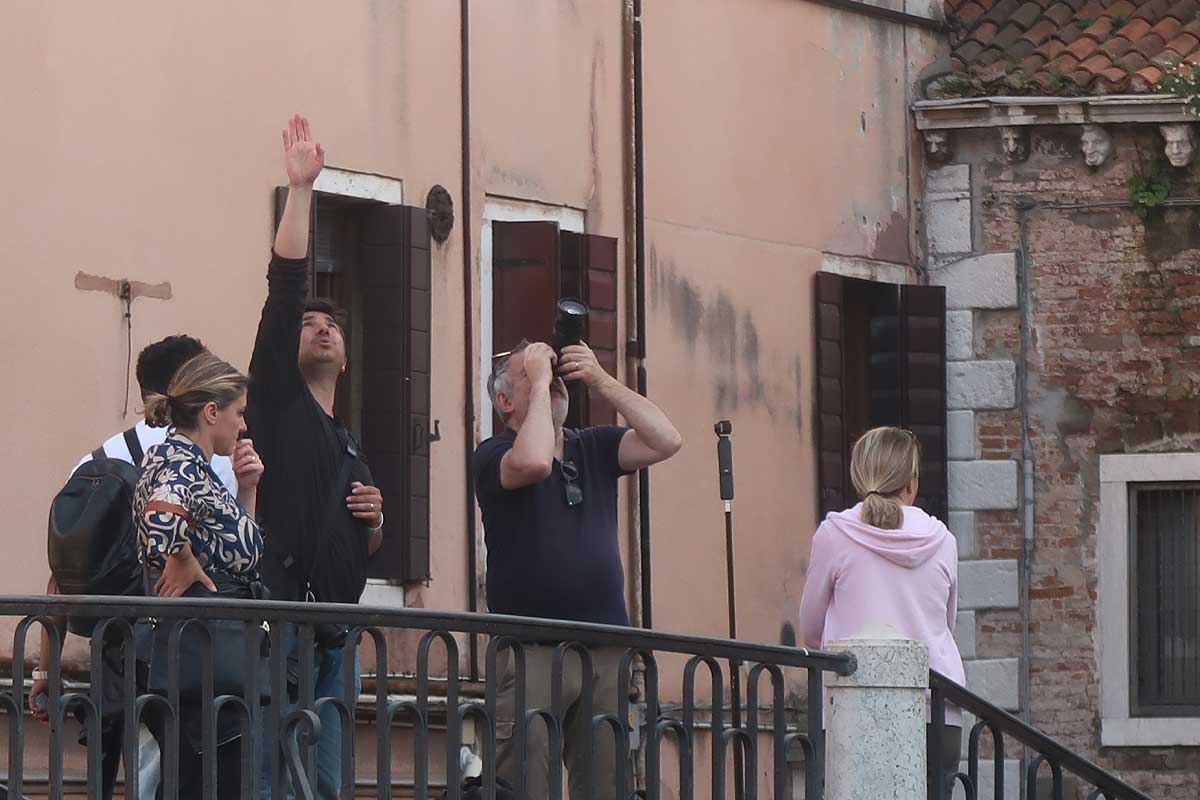 tourist with camera on bridge in venice